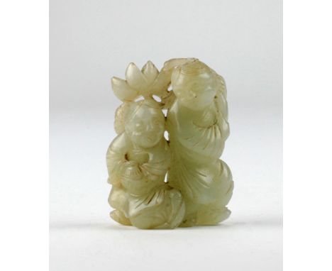 A 19th Century carved celadon jade Figurine, depicting two immortals holding a lotus leaf, approx. 5cms x 4cms (2" x 1 3/4").