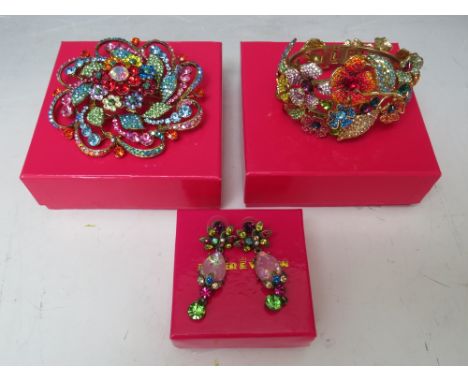 A BUTLER AND WILSON MULTI-COLOURED FLORAL THEME HINGED BANGLE, together with a Butler and Wilson floral style circular brooch