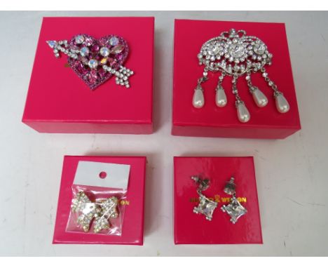 A BUTLER AND WILSON HEART WITH ARROW BROOCH, W 8.5 cm, a diamante &amp; pearl brooch - H 9.5 cm, a small bow brooch and a pai