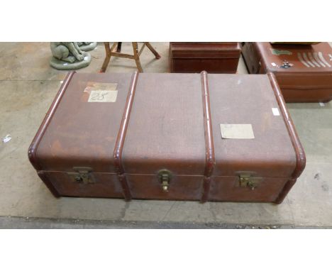 Three suitcases and a travel trunk 