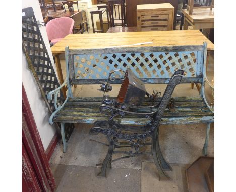 A cast iron bench, a pair of bench ends and a porch light 