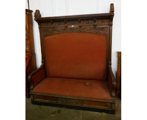 An Art Nouveau carved oak settle 