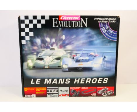 Carrera - A boxed Carrera "Evolution" #25805 1:32 "Le Mans Heroes" slot car set. The set comes with track, controllers, two c