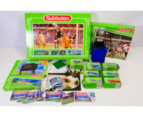 Subbuteo - A group of boxed Subbuteo items including stand, TV crew, fencing, bench figures, scoreboard, balls and more. They