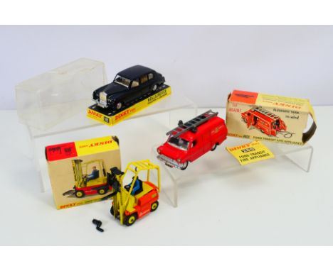 Dinky - Three boxed Dinky vehicles: #286 Ford Transit Fire Appliance with two fire axes inside the door. #404 Conveyancer For