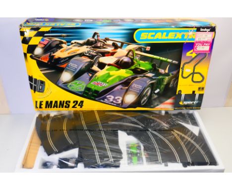 Scalextric - A boxed Scalextric C1114 1:32 "Le Mans 24" slot car set. The set appears to be in Mint condition with the conten
