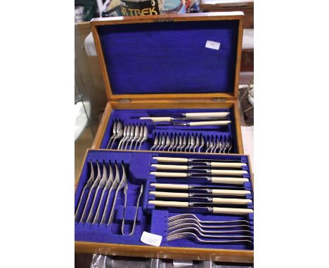 A vintage cased set of cutlery presented in an oak box 