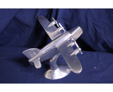 A vintage polished metal model of a aeroplane 