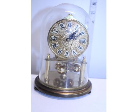 A vintage Kundo brass mantle clock under glass dome 
