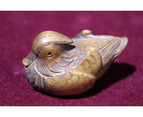 A 19th Century Japanese boxwood netsuke in the form of a Mandarin duck 
