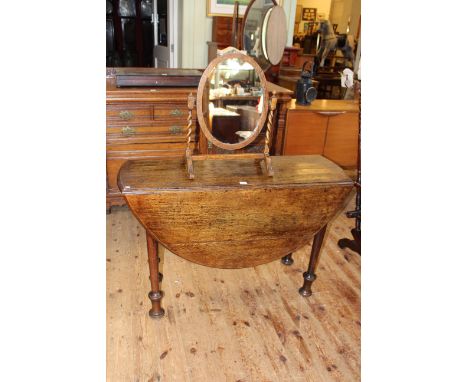 19th Century circular oak gate leg dining table, 73cm by 120cm diameter, together with an oak barley twist toilet mirror.