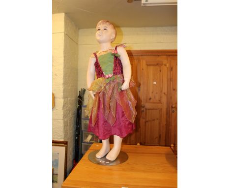 Dressed child mannequin on stand.