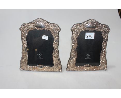 Pair of boxed embossed silver easel photograph frames.