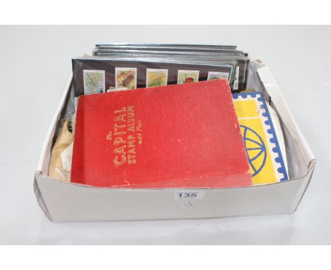 Presentation packs with an approximate face value of £35 and two schoolboy commonwealth stamp albums.
