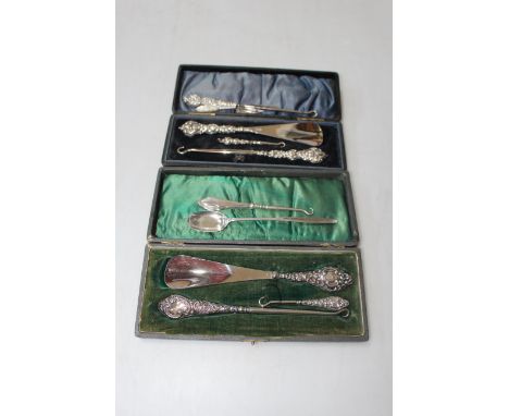 Collection of silver handled button hooks and shoe horns, trowel book mark and spoon (two cases).