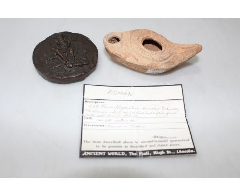 Roman terracotta oil lamp, 10.5cm across and resin replica coin weight (2).