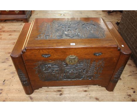 Oriental carved camphorwood trunk, 56cm by 91cm by 52cm.
