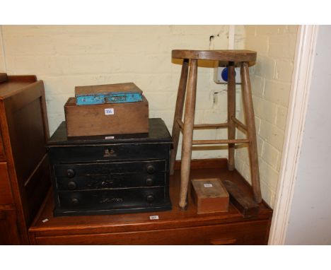 Elm stool, three drawer table cabinet, two boxes of printing type, ebony and boxwood chess set and pen box (6).