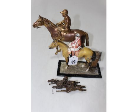 Three metal equestrian pieces, table lighter, horse and jockey, and pair of steeplechasers, tallest 21cm.