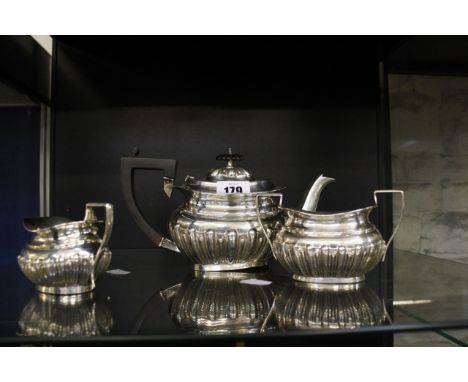 A Silver three piece tea service comprising tea pot, milk jug and sugar bowl, 15.15 troy oz approx. (471g) (in total)