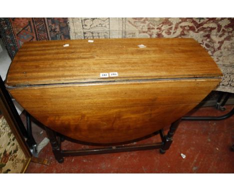 A mahogany oval top gateleg table on turned supports 90cm wide and two book racks, a needlework firescreen and an Art Nouveau