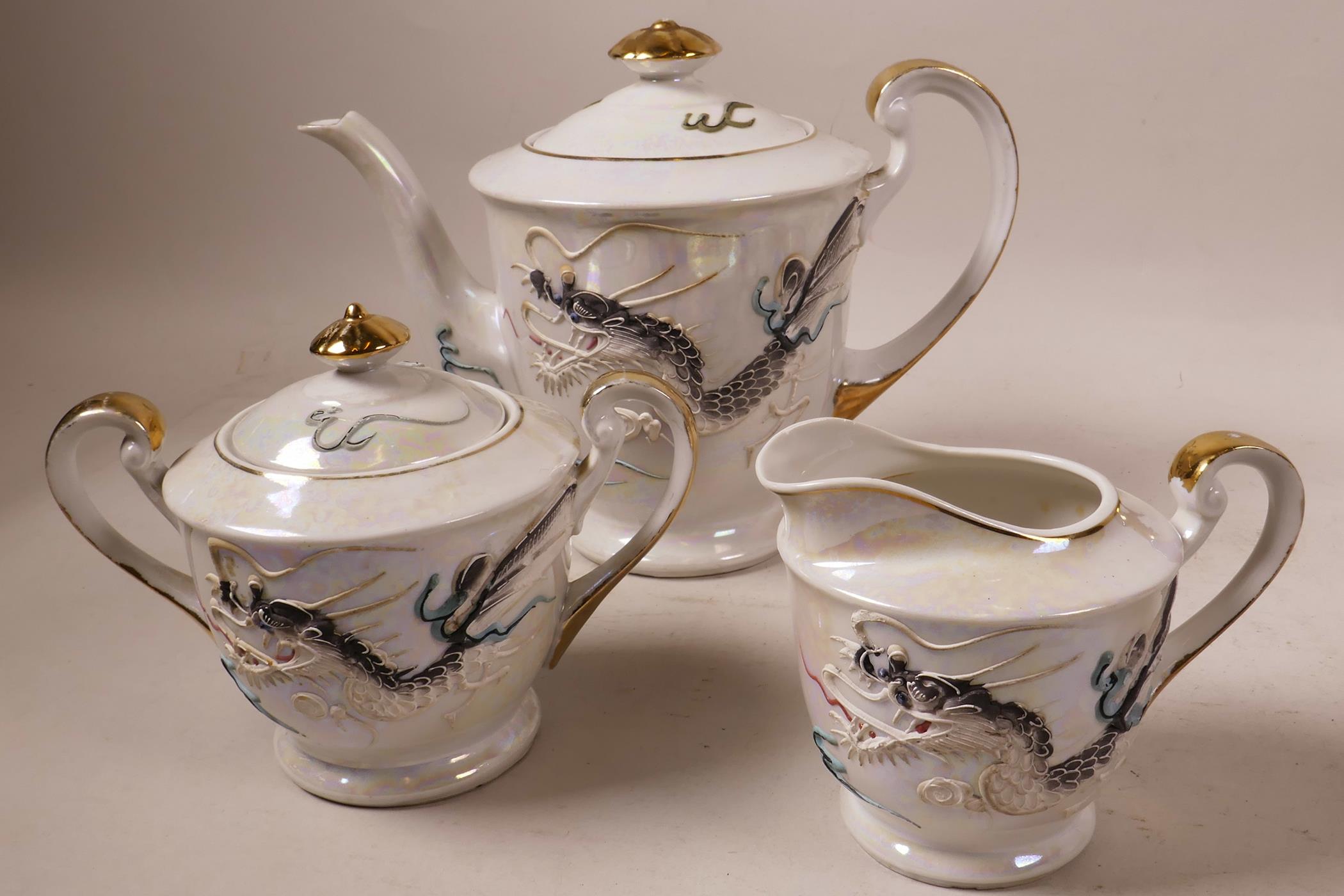 A 'Lucky' china Japanese moriage dragonware tea set with geisha