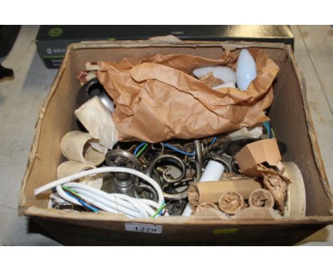 A box containing various light fittings, light shades, ornate brackets etc.