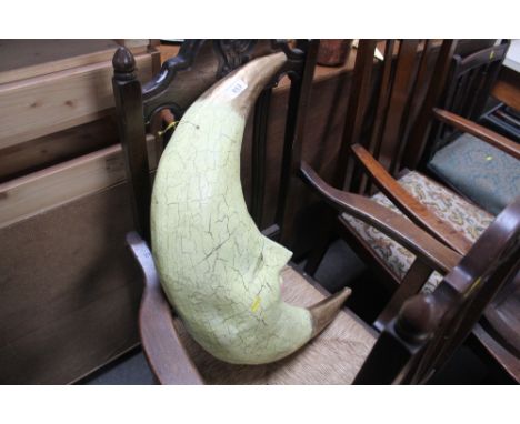 A papier mache model of a crescent moon