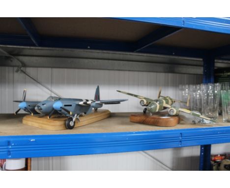 A diecast model of a V25 airplane and another of a Mosquito 