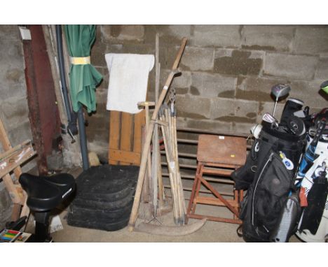 A quantity of garden tools to include drain rods, digging fork, rake, scythe, etc.