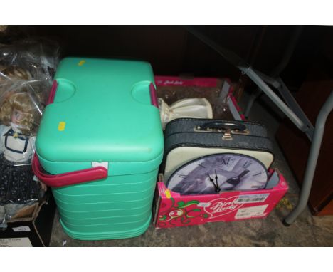 A cool box and a box containing a Petite typewriter, a modern wall clock, a table lamp and various drinking glasses