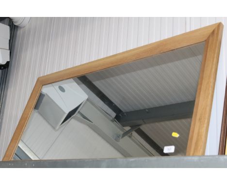 A light oak framed wall mirror 