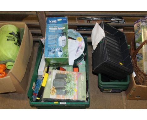 A plastic tray containing a roll of as new garden hose with attachments; potato planter; sprayer etc