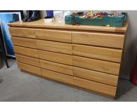 A modern light oak sideboard fitted three drawers above cupboard