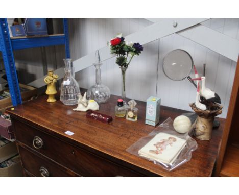 A magnifying glass on stand; a pottery figure initialled R R; two decanters; a scent bottle; necklace etc