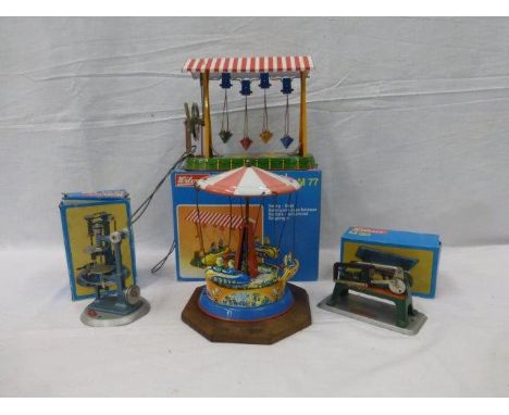 A Wilesco swing boat, boxed, one other and two boxed Wileso machines (hacksaw and drilling machine). 