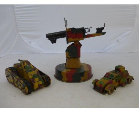A K.T. Trademark clockwork tinplate model of a tank, a clockwork tinplate armoured car and a tinplate revolving anti-aircraft