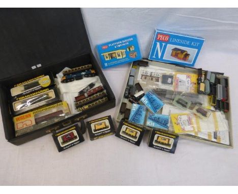 An assortment of Graham Farish boxed locomotives, carriages, rolling stock etc; also an assortment of Peco buildings, rolling