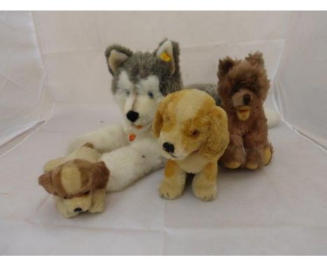 Four assorted Steiff dogs including Molly Husky. 