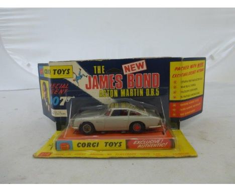 Corgi Toys - James Bond NEW Aston Martin DB5, silver, on plinth with documents inside, plastic vac-formed bubble packaging wi