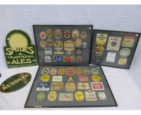 Three framed and glazed groups of beer bottle labels, a Smiles Traditional Ales enamel sign and an oval Ruddles plaque.
