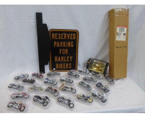 A complete collection of miniature Harley Davidson motorcycles including the 23K gold plated Gold Edition with a wall mounted