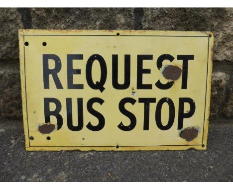 A 'Request Bus Stop' rectangular enamel sign, 16 1/2 x 10 1/2".