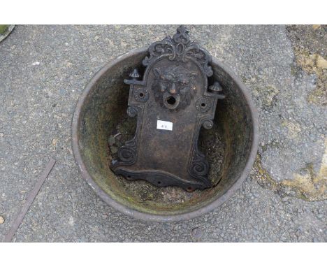 Cast iron wall mounted fountain head together with a iron trough