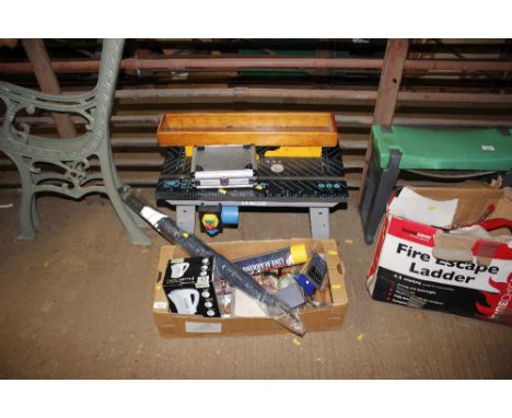 A table saw table together with a box of various hand tools