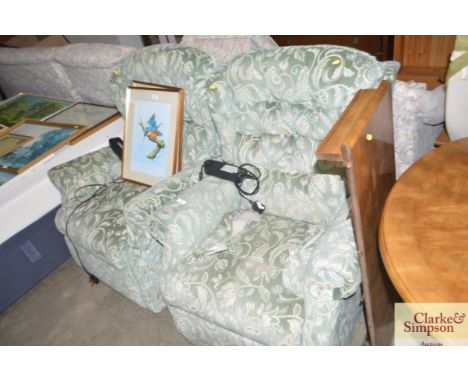 A pair of electric reclining button back armchairs