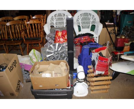 A large quantity of various sundry items to include wine rack; DVDs; car wheel trims; bags etc