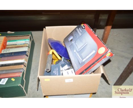 A box containing a microwave wall bracket; a halogen light; light bulbs etc