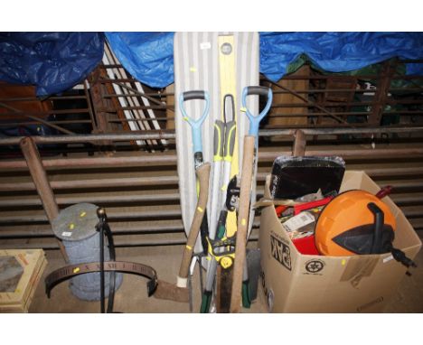 An ironing board and quantity of long handled gardening tools 