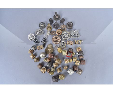 An assortment of various cap badges, to include Glider Pilot Regiment, Navy, Army &amp; Air Force Institutes (NAAFI), The Her